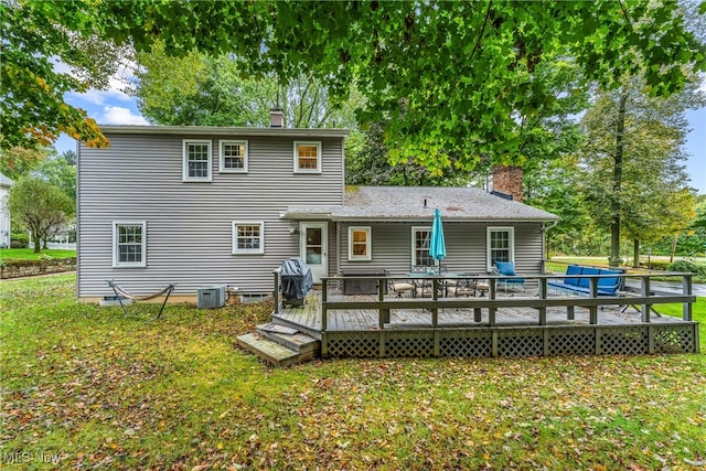 back of house featuring a lawn, central AC, and a deck