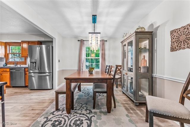 dining room featuring light hardwood / wood-style flooring and sink