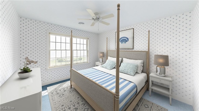 bedroom with ceiling fan and light carpet