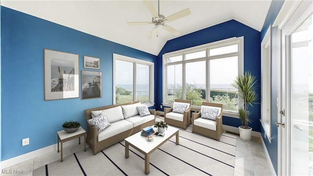 living room with ceiling fan, a healthy amount of sunlight, and vaulted ceiling