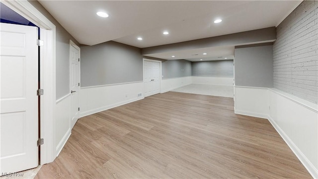 basement with light hardwood / wood-style floors