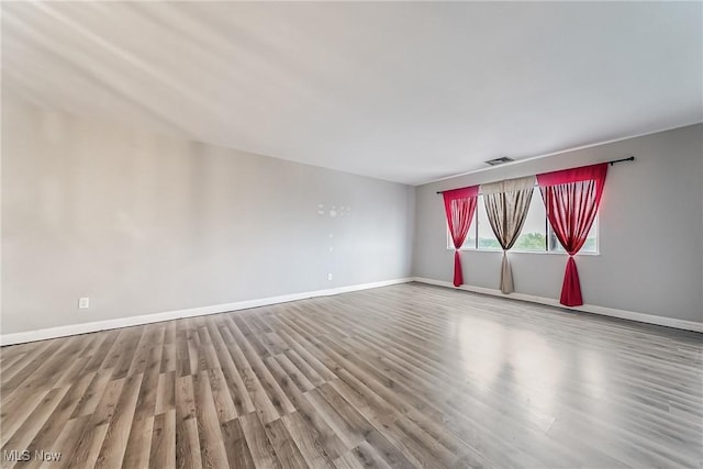 unfurnished room with light wood-type flooring