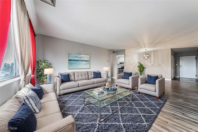 living room with a chandelier and wood-type flooring