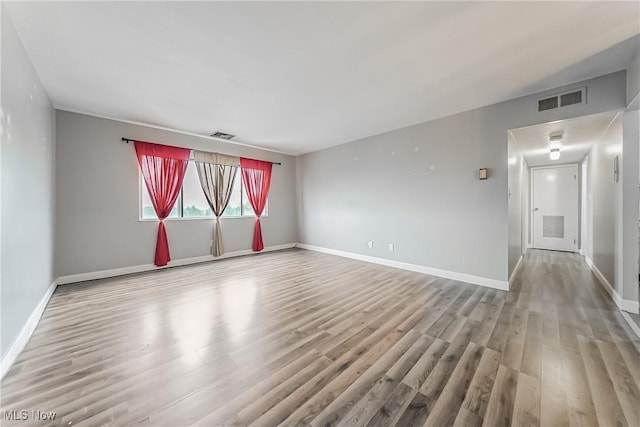 spare room with light hardwood / wood-style floors