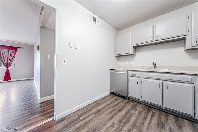 kitchen featuring stainless steel dishwasher, dark hardwood / wood-style floors, and sink