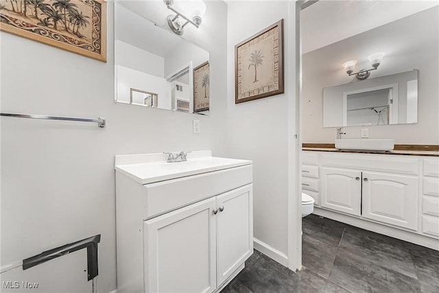 bathroom featuring tile patterned flooring, vanity, and toilet