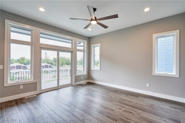 spare room featuring hardwood / wood-style floors and ceiling fan