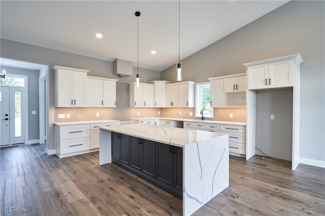 kitchen featuring a kitchen island, white cabinetry, and a healthy amount of sunlight