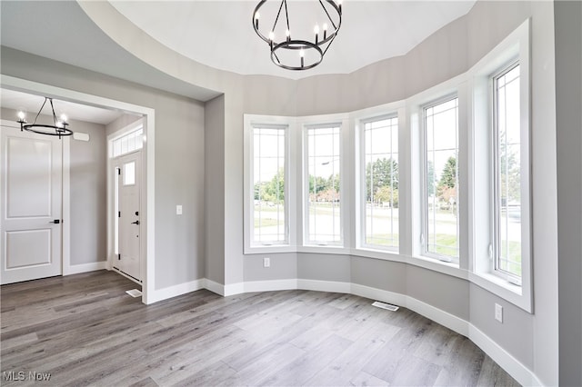 foyer featuring hardwood / wood-style flooring and a notable chandelier