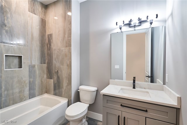 full bathroom with vanity, toilet, and tiled shower / bath