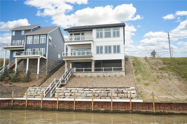 back of house featuring a balcony and a water view