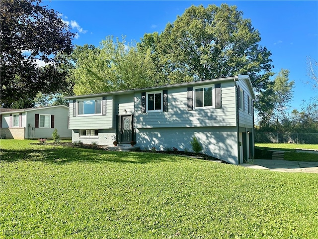 raised ranch featuring a front yard