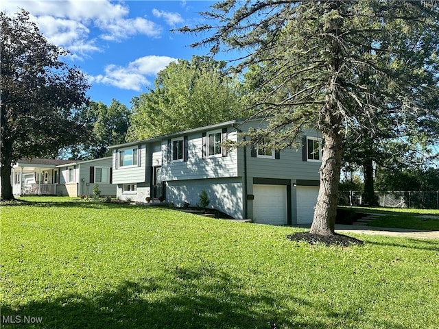 split foyer home with a front yard and a garage