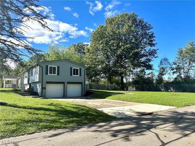 view of side of home with a yard and a garage