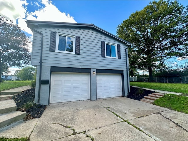 view of property exterior featuring a garage and a yard