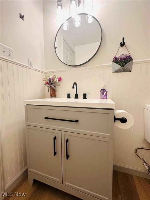 bathroom featuring hardwood / wood-style flooring, vanity, and toilet