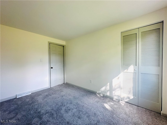 unfurnished bedroom featuring a closet and carpet flooring