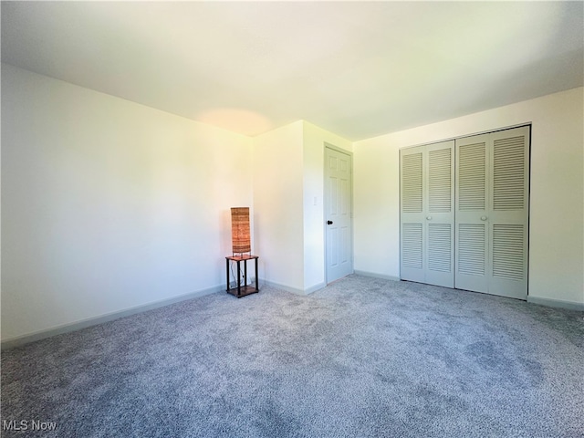 unfurnished bedroom featuring a closet and carpet floors