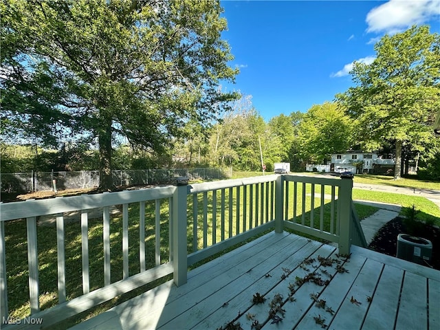 wooden terrace featuring a lawn