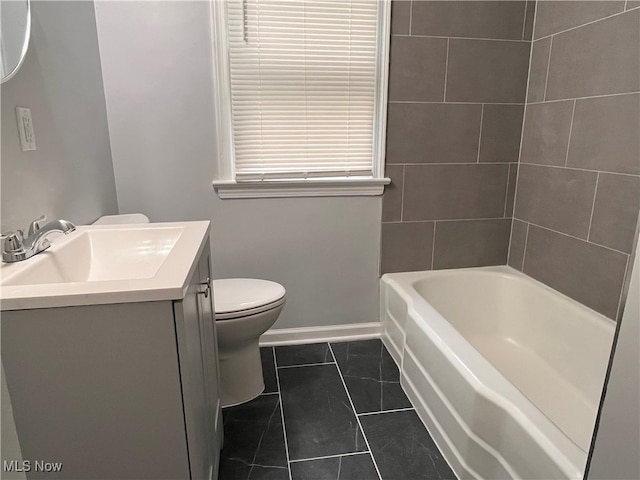 bathroom featuring vanity, a bathing tub, tile patterned flooring, and toilet