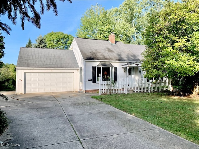 cape cod house featuring a garage and a front yard