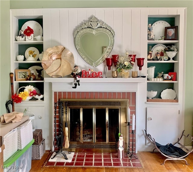 room details with a brick fireplace and wood-type flooring