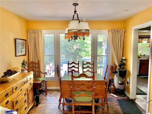 dining space with a notable chandelier, a wealth of natural light, and hardwood / wood-style floors