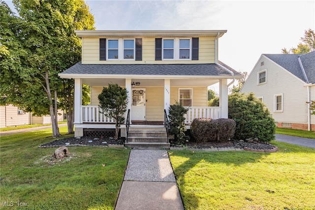 view of front of house with a porch and a front yard