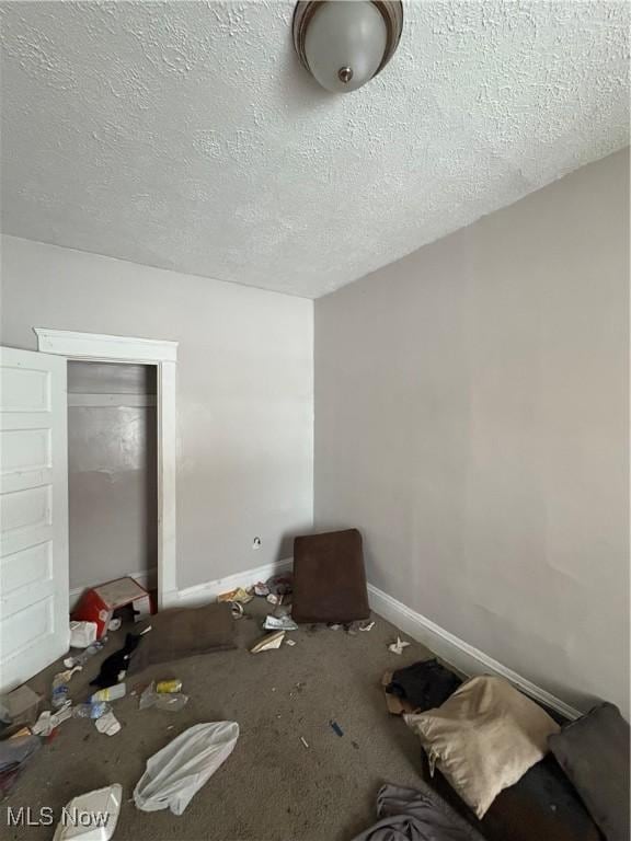 unfurnished bedroom featuring a closet and a textured ceiling