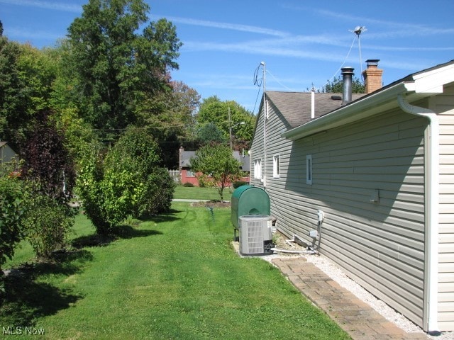 view of yard with central air condition unit