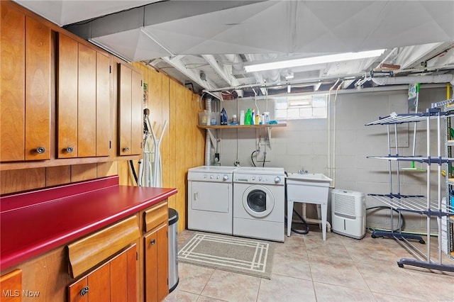 laundry area with separate washer and dryer and light tile patterned flooring