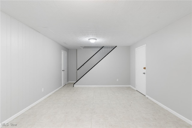 basement featuring a textured ceiling