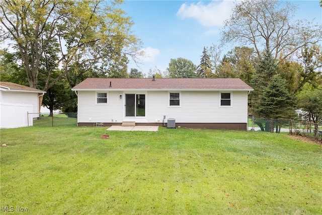 back of property featuring a lawn, a patio area, and central AC