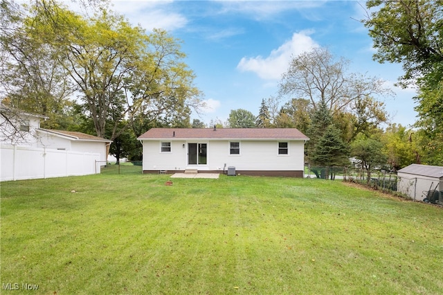 rear view of house with a lawn and a patio area