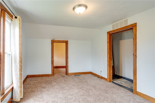 spare room with plenty of natural light and light carpet