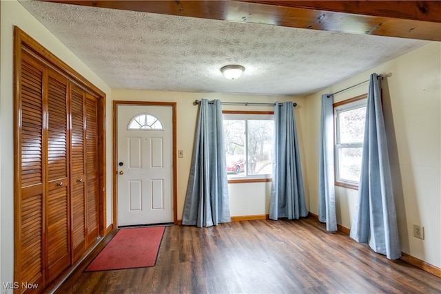 entryway featuring dark hardwood / wood-style flooring and a textured ceiling