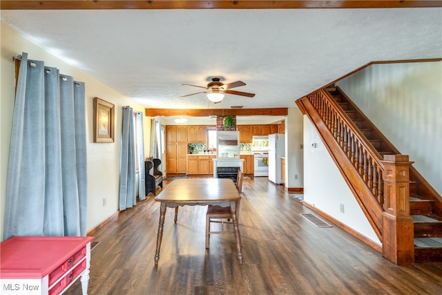 interior space featuring a textured ceiling, ceiling fan, and dark hardwood / wood-style floors