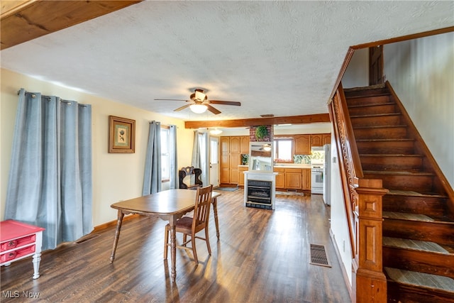 dining room with a textured ceiling, ceiling fan, beverage cooler, and dark hardwood / wood-style floors