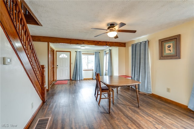 dining room with dark hardwood / wood-style floors, ceiling fan, and a textured ceiling