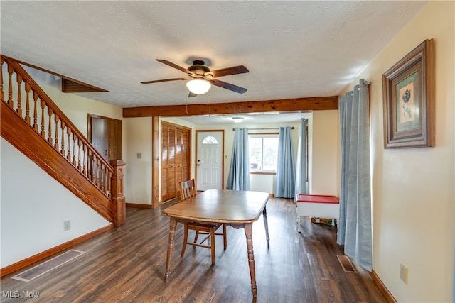 dining space featuring a textured ceiling, ceiling fan, and dark wood-type flooring