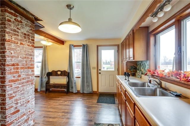 kitchen featuring beam ceiling, sink, and dark hardwood / wood-style floors