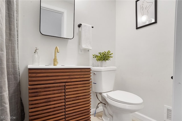 bathroom with vanity, toilet, and tile patterned floors