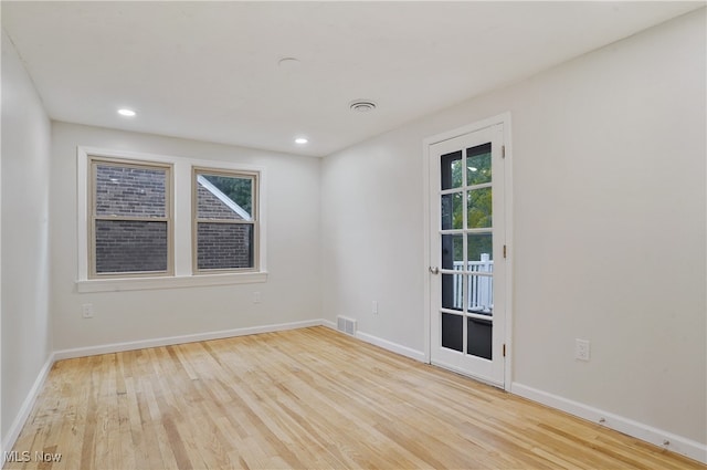 unfurnished room with light hardwood / wood-style floors