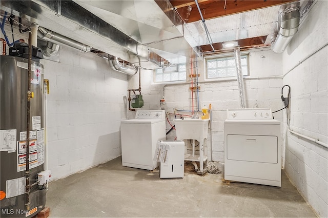 washroom with washing machine and dryer and gas water heater