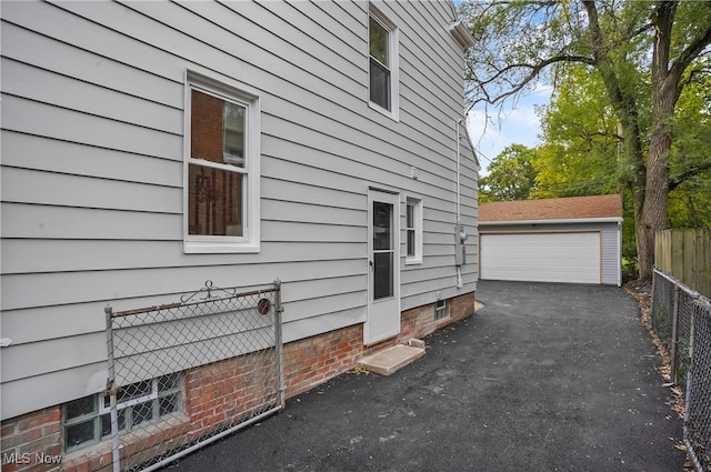 view of home's exterior featuring an outdoor structure and a garage