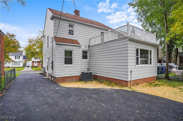 rear view of property with a balcony and central air condition unit