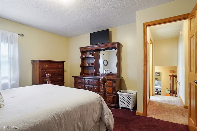 bedroom with a textured ceiling and carpet flooring