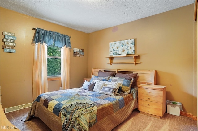 carpeted bedroom with a textured ceiling