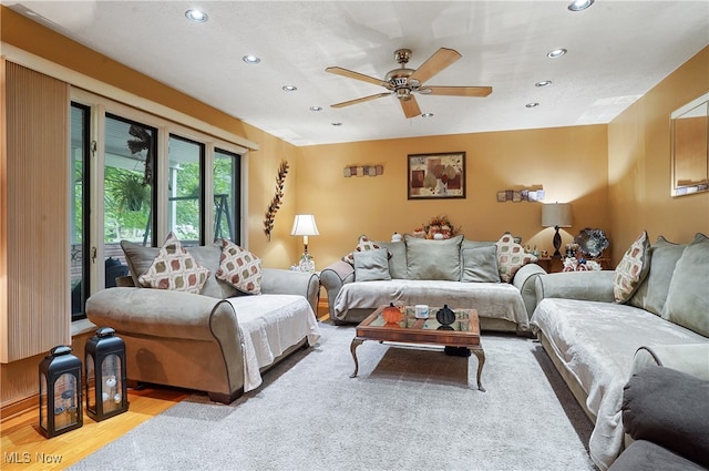 living room featuring light wood-type flooring and ceiling fan