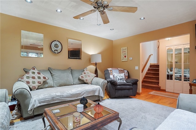 living room featuring light wood-type flooring and ceiling fan